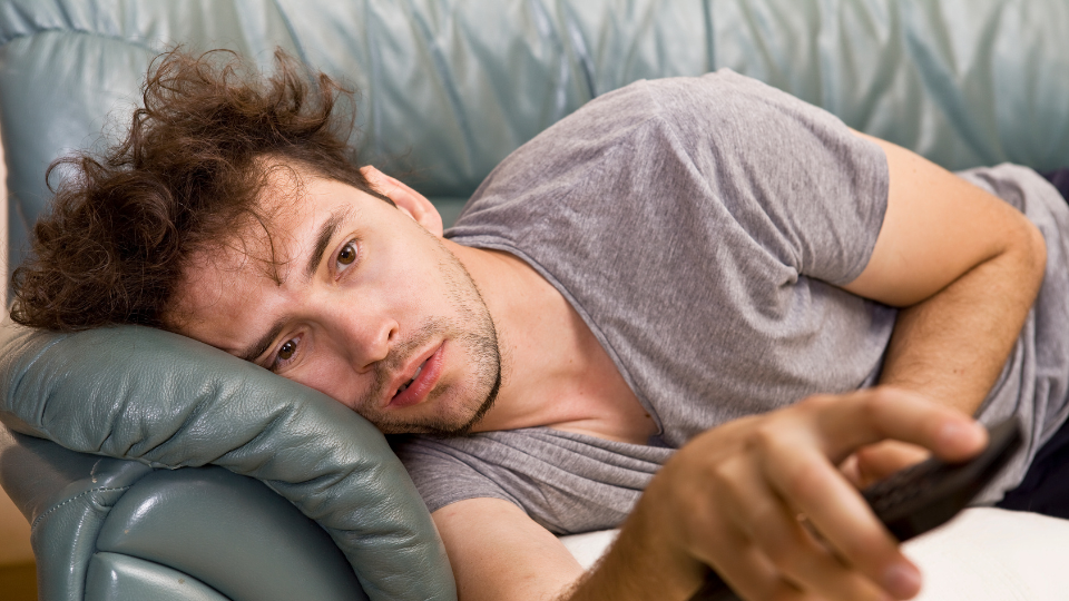 A business man showing laziness instead of working, portraying cognitive laziness