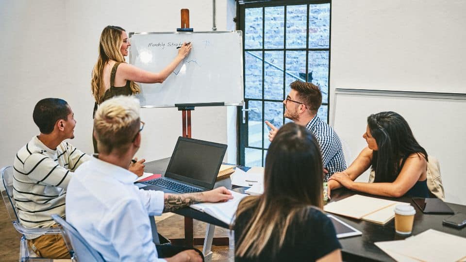 Business Owner doing monthly strategic meeting wit her employees.