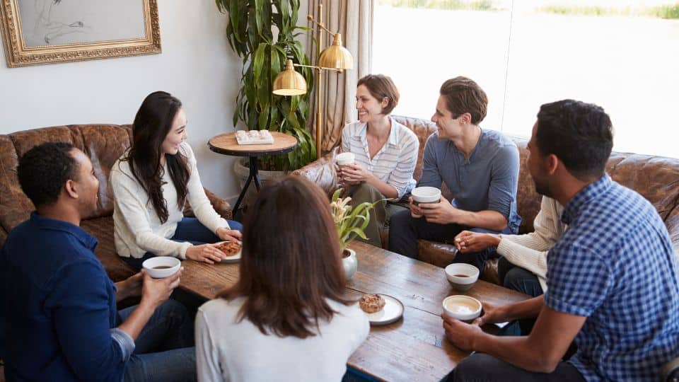 Business owner with employees sharing their insights and opinions after the think-write-share session in their office.