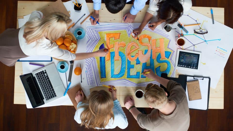 A business team promoting creativity by collaborating with fresh ideas