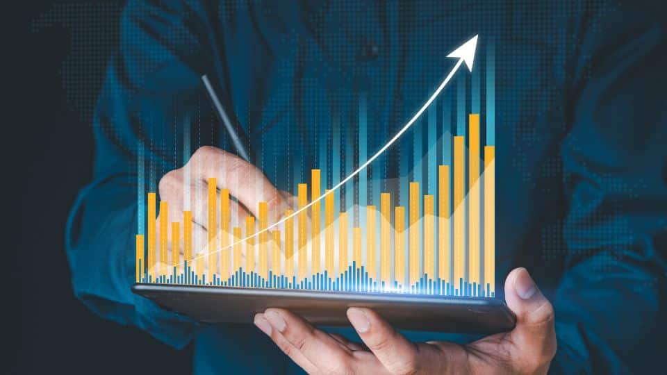 Man showing his hands writing while showing the chart of business growth rate